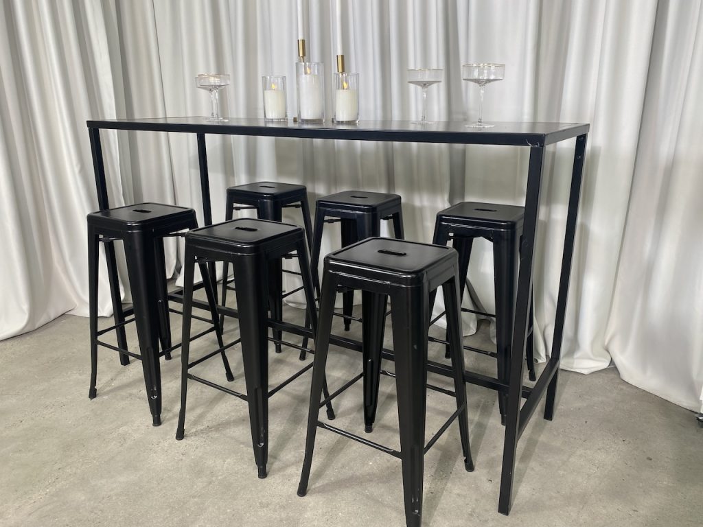 black rectangular tapas table and black tolix stool