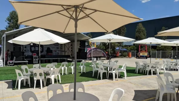 community event with market umbrellas, plastic chairs and cafe tables