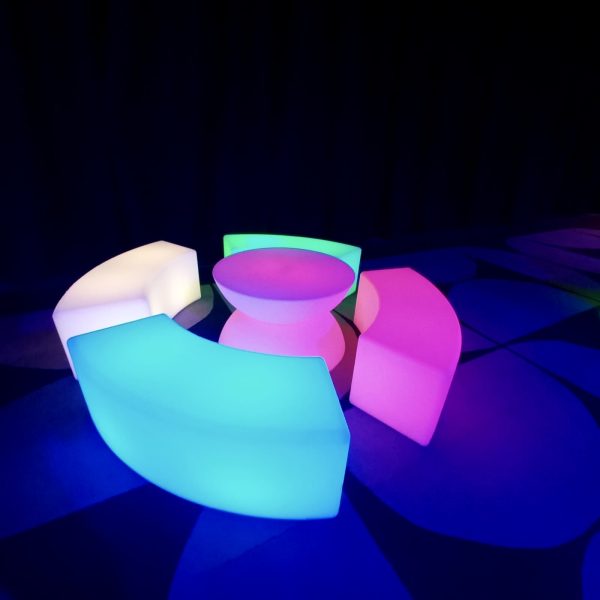 glow curve bench and glow coffee table at an evening event