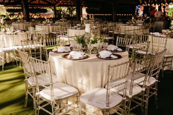 wedding reception with tables and gold tiffany chairs