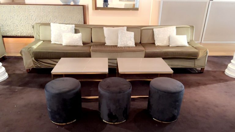 black velvet ottoman stools with rectangular gold coffee table