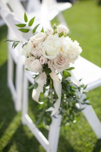 flower bouquet attached to wedding chair